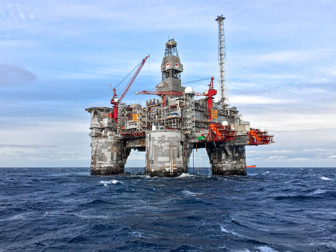 discover An offshore oil platform in Norways North Sea under a clear blue sky.