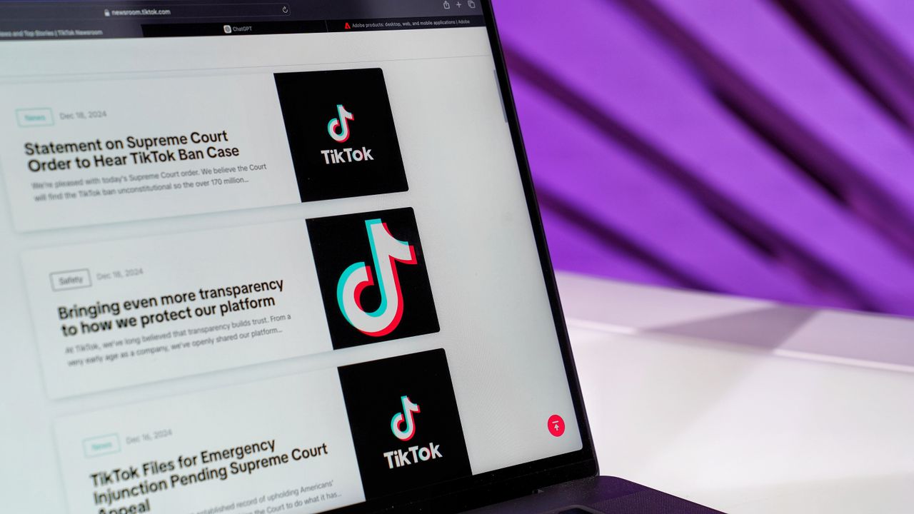gallery-02 Close-up of laptop screen showing TikTok news articles with a purple background.